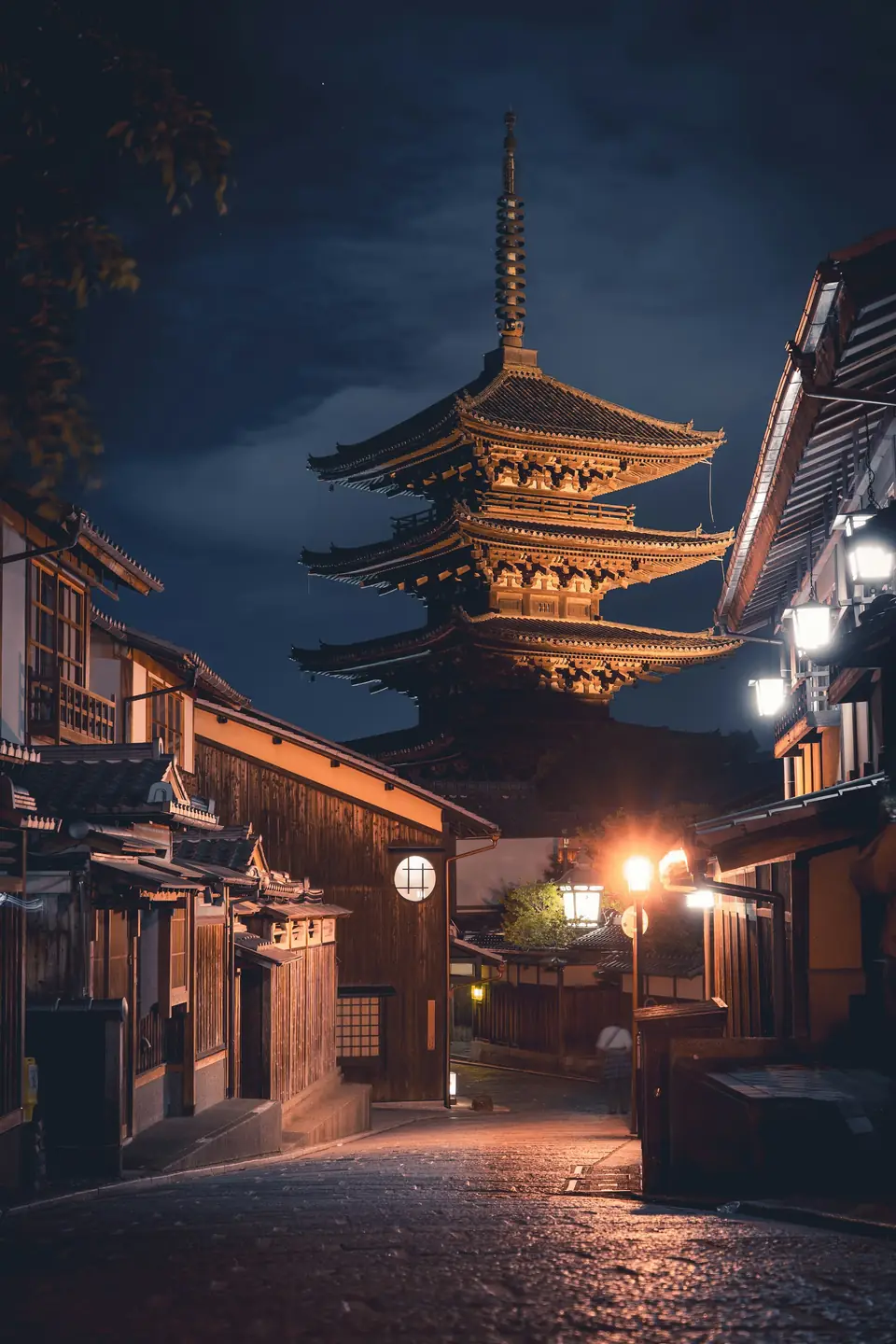 Pagoda Yasaka iluminada al anochecer en una calle tradicional de Kioto, Japón